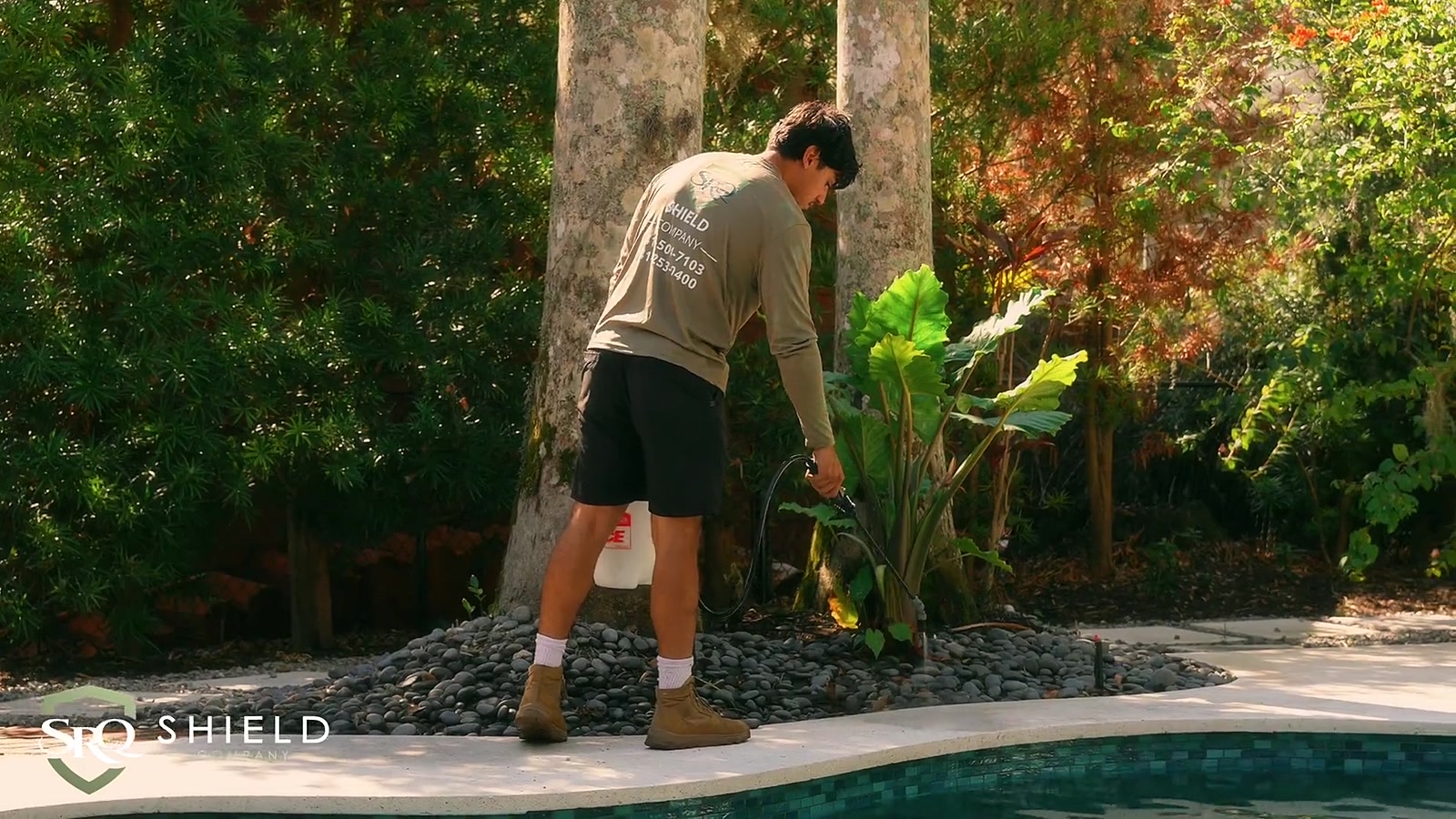 SRQ Shield crew treating a poolside walkway in Bradenton